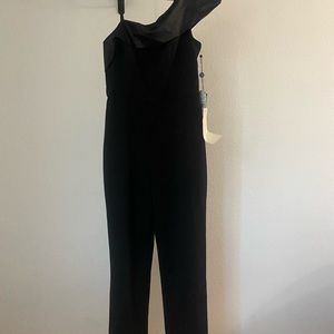 A black jumpsuit with side zipper.(2) available.